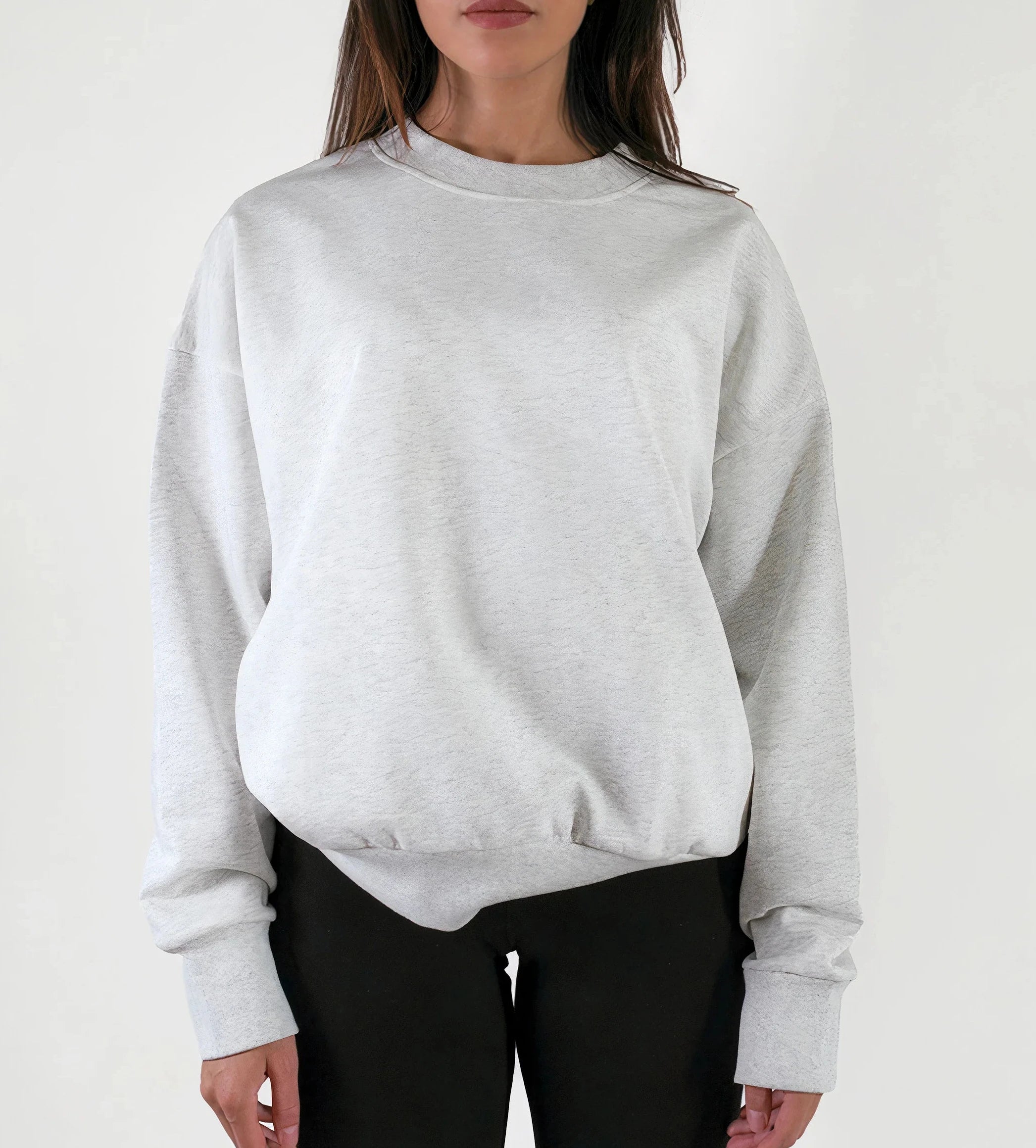 Person wearing a light gray sweatshirt on a white background